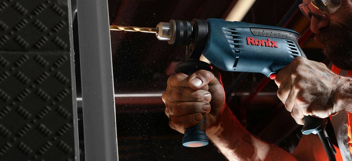 Close-up of cordless construction staple gun battery and magazine loading